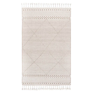 Handwoven beige and white wool rug with geometric kilim pattern and braided fringe for modern, boho and nordic interiors.