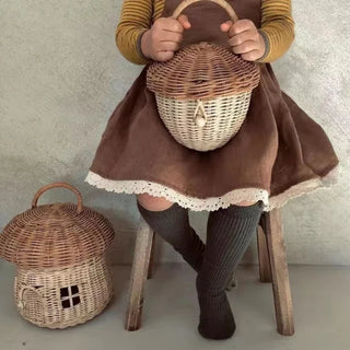 Handwoven rattan mushroom-shaped basket with arched door and handle, designed for children's toy storage and whimsical nursery decor.