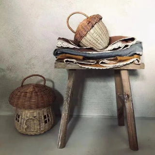 Natural rattan wicker pine cone basket with lift-top lid and handle, designed for children’s storage, play, or nursery decor.