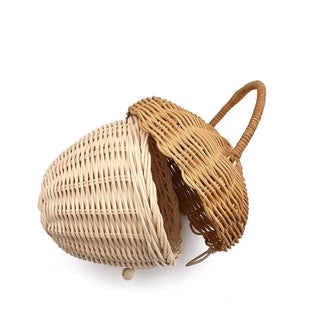 Natural rattan wicker pine cone basket with lift-top lid and handle, designed for children’s storage, play, or nursery decor.