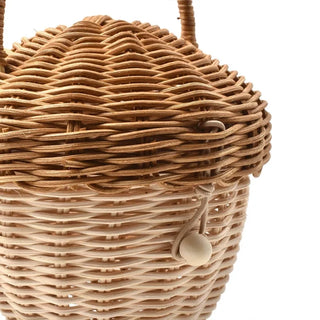 Natural rattan wicker pine cone basket with lift-top lid and handle, designed for children’s storage, play, or nursery decor.