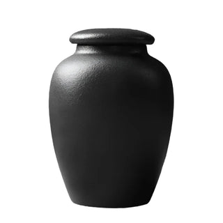 Elegant black ceramic large storage jars in various shapes and sizes, featuring a soft textured finish and airtight lids. Perfect for storing tea, coffee, sugar, and spices while adding a modern, sophisticated touch to any kitchen countertop.