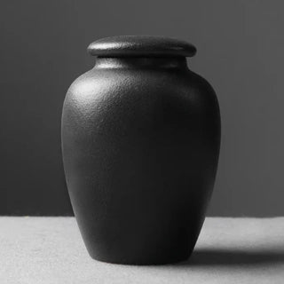 Elegant black ceramic large storage jars in various shapes and sizes, featuring a soft textured finish and airtight lids. Perfect for storing tea, coffee, sugar, and spices while adding a modern, sophisticated touch to any kitchen countertop.