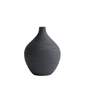 Modern ceramic flower black vases from the Emi Vases collection, featuring a sleek, minimalistic design with ribbed texture. Crafted from high-quality ceramic, these vases enhance contemporary, minimal or scandi home décor with their sculptural elegance. Perfect for displaying as a standalone piece or grouped together on a shelf or console, they add sophistication and refinement to any room.