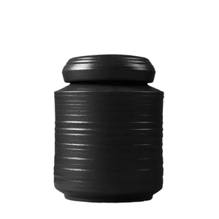 Elegant black ceramic storage jars in various shapes and sizes, featuring a ribbed textured finish and airtight lids. Perfect for storing tea, coffee, sugar, and spices while adding a modern, sophisticated touch to any kitchen countertop.