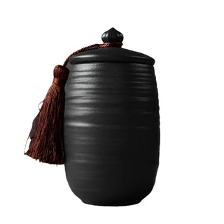 Elegant black ceramic large storage jars in various shapes and sizes, featuring a ribbed textured finish and airtight lids. Perfect for storing tea, coffee, sugar, and spices while adding a modern, sophisticated touch to any kitchen countertop.