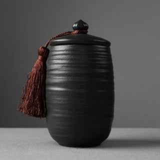 Elegant black ceramic large storage jars in various shapes and sizes, featuring a ribbed textured finish and airtight lids. Perfect for storing tea, coffee, sugar, and spices while adding a modern, sophisticated touch to any kitchen countertop.