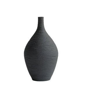 Modern ceramic flower black vases from the Emi Vases collection, featuring a sleek, minimalistic design with ribbed texture. Crafted from high-quality ceramic, these vases enhance contemporary, minimal or scandi home décor with their sculptural elegance. Perfect for displaying as a standalone piece or grouped together on a shelf or console, they add sophistication and refinement to any room.