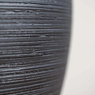 Black ribbed ceramic minimalist vase – a stylish decorative ornament perfect for modern and zen-inspired home decor. The Bo textured round vase adds an elegant touch to any space, ideal for coffee tables, shelves, or mantel displays. A must-have home accessory for a natural and contemporary aesthetic.