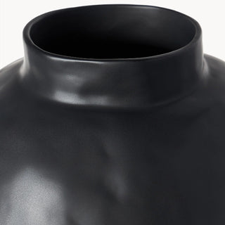 Black ceramic sculptural vase with a minimalist design, available in two sizes that can be styled together. The vase features a creative, artistic shape and a sleek black finish, perfect for adding a bold, statement look to any modern or contemporary interior.