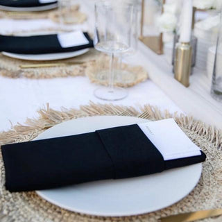 Set of four handmade black cotton table napkins with soft texture and minimalist design, styled for a modern table setting.
