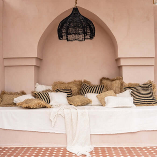 Endah Black Handwoven Rattan Pendant Lampshade – interwoven in a creative, organic shape, this ceiling light  is a statement piece, perfect for natural home decoration. This hanging lamp comlements boho, Scandi, and Wabi-Sabi aesthetics, adding warmth and texture to any space. Ideal for eco-conscious interiors.