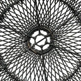Black handwoven rattan pendant light with dome-shaped silhouette and airy open weave.