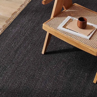 Textured black jute and cotton rug adding warmth to Scandinavian-inspired space