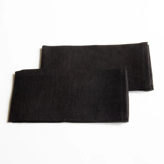 Set of two black linen napkins for minimalist dining spaces.