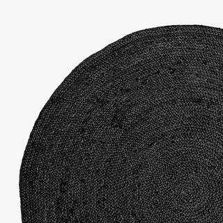 Round black jute rug handwoven with natural braided fibres—minimalist, sustainable, and ideal for Scandi or boho interiors.