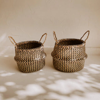 Small and medium size handwoven seagrass basket in natural and black, ideal for minimalist and boho storage or decorative use.