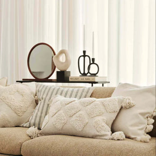 Minimalist black candle holders styled on a modern console with Nordic décor.