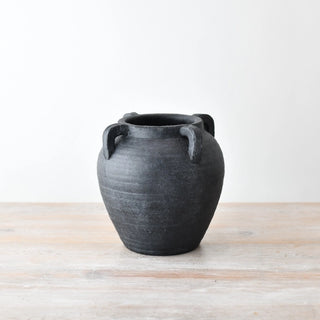 Black terracotta vase with rustic matte texture and loop handles.