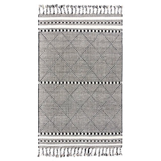 Handwoven black and white wool rug with geometric kilim pattern and braided fringe for modern, boho and nordic interiors.