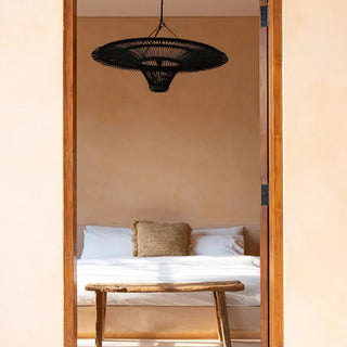 Black handwoven rattan pendant light with funnel shape — minimalist, natural ceiling light for modern or rustic interiors.