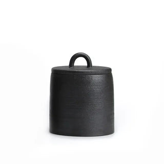 Black Japanese stoneware storage jar with lid, featuring a rustic finish. Perfect for kitchen organization, this ceramic canister provides airtight storage for tea, coffee, spices, or pantry essentials. A stylish and functional addition to natural homeware and minimalist décor.