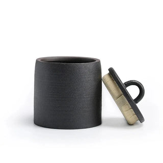 Black Japanese stoneware storage jar with lid, featuring a rustic finish. Perfect for kitchen organization, this ceramic canister provides airtight storage for tea, coffee, spices, or pantry essentials. A stylish and functional addition to natural homeware and minimalist décor.