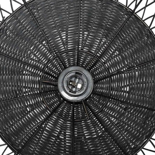 Black Tama handwoven wicker pendant light with crisscross rattan weave, creating a warm, ambient glow in modern or bohemian interiors.
