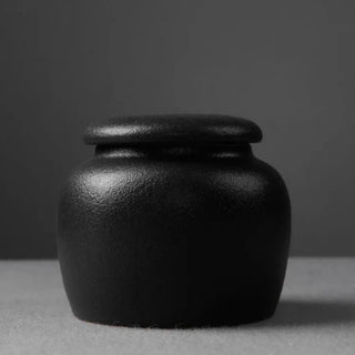 Black textured ceramic storage jar  with lid.