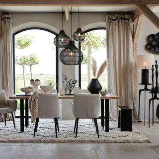 Modern scandi dining room featuring a cluster of minimalist black pendant ceiling lights.