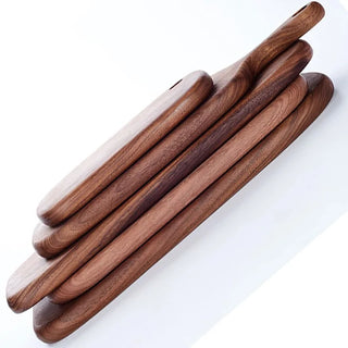 Collection of solid black walnut chopping or serving boards in various shapes and sizes, Arkaim Home