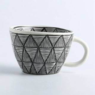Hand-painted ceramic mug with a black and white geometric pattern and an irregular shape, Arkaim Home 