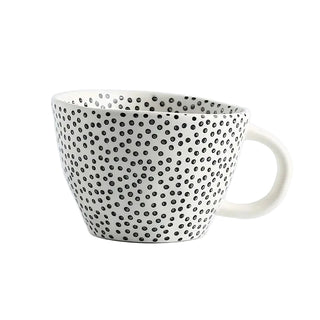 Irregular-shaped ceramic coffee mug with a black polka dot pattern, Arkaim Home 