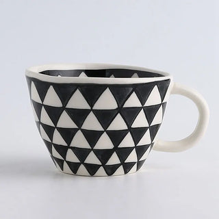 Hand-painted ceramic mug with a black and white geometric pattern and an irregular shape, Arkaim Home