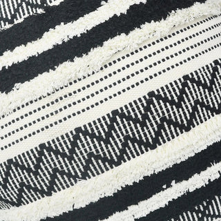Zohra black and white cotton cushion cover with hand-tufted embroidery and tasselled corners. Moroccan-inspired design for natural and modern décor..