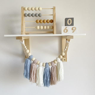 Wooden abacus toy with pastel-colored beads, placed on a neutral surface—ideal for counting and sensory play.
