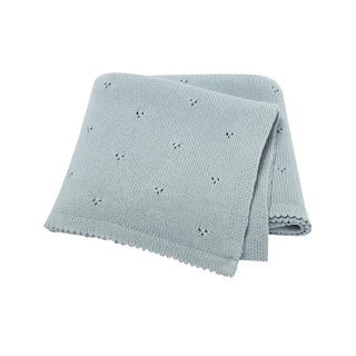 Gigi cotton knit baby blanket folded in soft pastel blue.