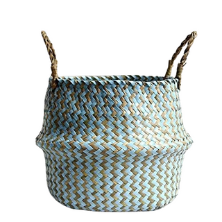 Handwoven natural and blue seagrass storage basket with handles, perfect as a stylish hanging basket, pot planter, or decorative storage solution. This eco-friendly, two-tone basket adds a touch of natural boho touch while keeping your space organized. Shop handcrafted storage baskets at our natural homeware store.