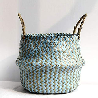 Handwoven natural and blue seagrass storage basket with handles, perfect as a stylish hanging basket, pot planter, or decorative storage solution. This eco-friendly, two-tone basket adds a touch of natural boho touch while keeping your space organized. Shop handcrafted storage baskets at our natural homeware store.