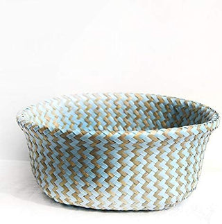 Handwoven natural and blue seagrass storage basket with handles, perfect as a stylish hanging basket, pot planter, or decorative storage solution. This eco-friendly, two-tone basket adds a touch of natural boho touch while keeping your space organized. Shop handcrafted storage baskets at our natural homeware store.