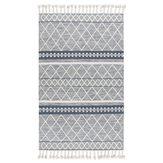 Handwoven blue and white wool rug with geometric kilim pattern and braided fringe for modern, boho and nordic interiors.