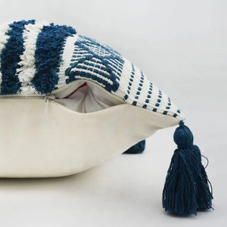 Zohra blue and white cotton cushion cover with hand-tufted embroidery and tasselled corners. Moroccan-inspired design for natural and modern décor.