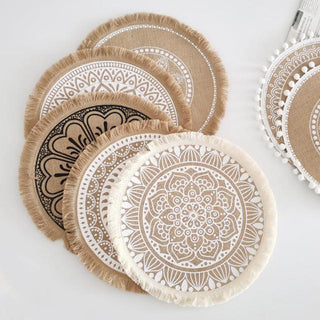 Set of four hessian boho placemats featuring a natural fibre weave and mandala design, perfect for rustic or coastal table settings.