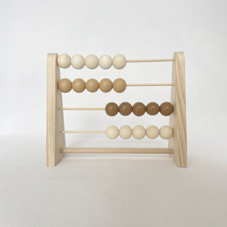 Wooden abacus toy with pastel-colored beads, placed on a neutral surface—ideal for counting and sensory play.