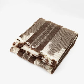 Rustic virgin wool blanket in a brown and beige geometric pattern.