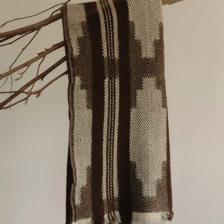 Artisan woven Shevitza wool blanket adding warmth to a minimalist Scandi décor.
