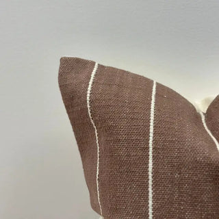 Brown striped cushion for natural and layered interiors.