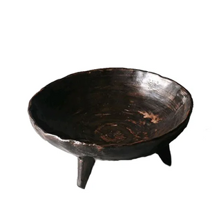 Brown handmade ceramic raised serving dish with an uneven, textured surface and hand-rubbed glaze. This wabi-sabi inspired decorative fruit bowl adds a natural, organic touch to any home. Perfect as a unique display piece or functional home accessory. Shop artisanal pottery at our natural homeware store.