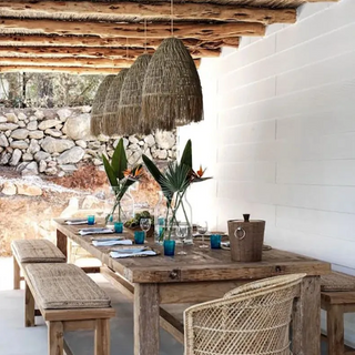 A handwoven rattan and raffia straw pendant light. This natural Cahya pendant lampshade offers a stylish ceiling light, perfect for boho, Scandi, and wabi-sabi home decor. The earthy design enhances any space with its organic charm, making it an ideal choice for natural home decoration and creating a warm, rustic atmosphere. Perfect for adding a unique, sustainable touch to your living room, dining room, or bedroom lighting.