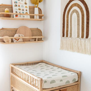 Handmade rattan wall shelf with curved design, styled in a child’s room for displaying books, toys, and keepsakes in a natural Boho aesthetic.